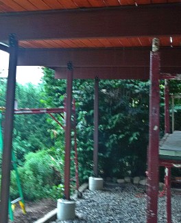 In this photo the metal drip edge at the top of the girders can be seen. The girders have been primed two coats with a high quality adhesion primer and the posts are sealed and stained. The Decking was pre-finished using Duckback Superdeck.